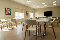 Meeting room with tables and chairs for guests.