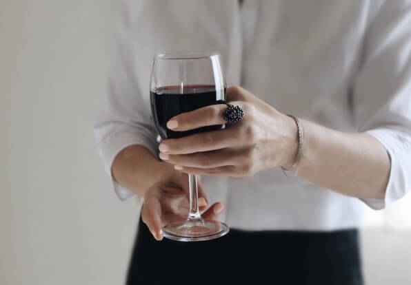 Silver_Maple_Alcohol_Treatment A woman holding a glass of red wine.