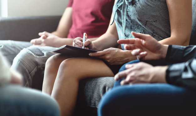 Inpatient vs Outpatient Addiction Rehab An up-close picture of a group therapy session in outpatient rehab.