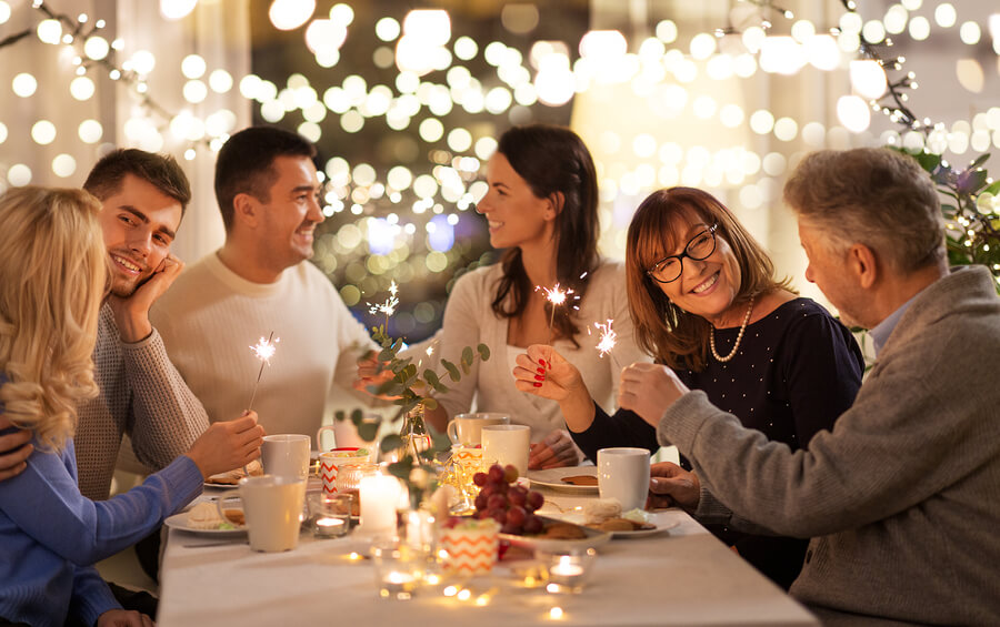How to Help Your Loved One Stay Sober During the Holidays Family and friends enjoying a holiday themed party.