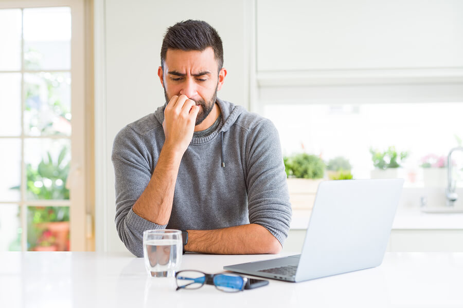Relapse Prevention During Social Isolation A man in recovery feeling stressed while at home.