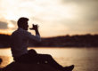 A man addicted to alcohol drinking outside.