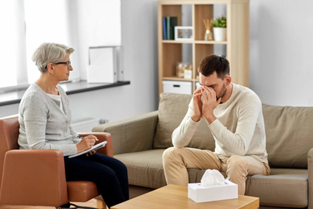 A man in recovery meeting with his therapist for individual treatment.