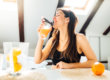 A woman drinking a smoothie to boost her immune system.