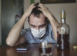 A man drinking too much at home because of the stress from social distancing.