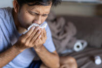 A man suffering from allergy symptoms after drinking.